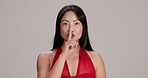 Face, secret and woman in studio, private and expression for valentines day, affair and flirting for romance. Mockup space, happy and hand gesture for silence, Asian person and sneaky date in Japan