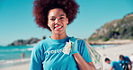 Volunteer, woman and face for cleaning at beach with plastic bag, waste management or ocean trash disposal. NGO project, laughing or girl with community service, environment conservation or recycling