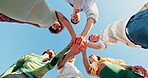 Huddle, hands together and support with low angle of people for community, trust and connection. Diversity, helping others and solidarity with group of friends in nature for teamwork and partner