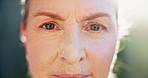 Mature, woman, face and outdoor with closeup, eye health and contact lenses in the morning. City, retirement and natural beauty with health, wellness and care with female person from France in sun