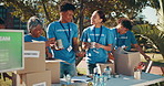 People, volunteering and outdoor with boxes for packing, donation drive and community service. NGO team, happy or charity in city for social responsibility, distribution and supplies for poverty help