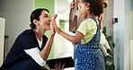 Dentist, high five and welcome with kid, reception and appointment for checkup. Child healthcare, smile and greeting with girl for dental care, oral hygiene and teeth cleaning service in clinic