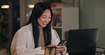Laptop, phone and smile with Japanese business woman in home office at night for communication. Computer, creative and design with happy Asian employee typing in workplace for web development