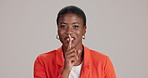 Black woman, face and studio for mystery with finger, confidential privacy and white background. Female person, quiet revelation and gesture for secret announcement, portrait and emoji for whisper