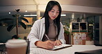 Business, woman and taking notes on laptop at office for research on headline story as journalist. Asian person, employee and busy at night with project deadline for news article and publication