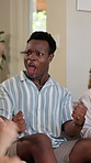 Watching tv, score and friends with man on sofa for sports tournament, competition and games. Results, fans and high five with people in living room at home for championship match, winner and goal