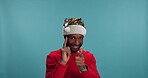 Christmas dance, face or man in studio with celebration, party or smile on blue background. African person, yes or funny model with thumbs up, excited or event with joy, Xmas hat or winner or holiday
