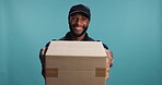 Black man, box or face of delivery guy in studio for courier service or supply chain package. Giving, portrait or worker on blue background for shipping distribution, online shopping or post services