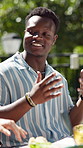 Friends, laughing and happy man with food in backyard for celebration, new years event or lunch. Bonding, party and eating with funny people in home for summer social, reunion and bbq meal together