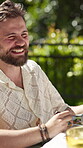 Friends, talking and happy man with food in backyard for laughing, new years event or lunch. Bonding, outdoor party and eating with people in home for summer social, reunion and bbq meal together