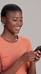 Studio, phone or African woman laughing at funny video on social media for humor on white background. Relax, reading and happy girl with smile, news or meme joke on streaming for entertainment online