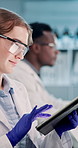 Tablet, science and woman in laboratory for research, problem solving or check microscope for experiment. Professional, medical scientist or digital technology for innovation, typing or development