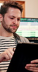 Man, tablet and producer in recording studio for engineering, research and email for production. Musician, tech or typing in music room for song writing, creativity or social media post for followers