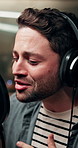 Headphones, man and musician singing in recording studio for audio production, creative performance or talent. Music, person or professional on microphone for sound, hip hop or artist broadcast voice