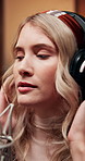 Headphones, girl singing and musician in recording studio for audio production, creative performance or talent. Music artist, microphone and professional with sound, pop or broadcast voice for album