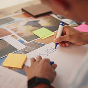 Vision board, drawing and man by table for planning life goals ...