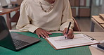 Woman, hands and writing with laptop for inventory checklist, stock control or expenses at warehouse. Closeup, female person or distributor checking supplies with clipboard for order costs or pricing