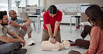 Workplace, first aid and training people in cpr, explain procedure and learn to resuscitate on dummy. Office, floor workshop and instructor speaking to group, medical support and paramedic coaching