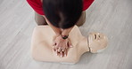 Person, hands or dummy with CPR above for first aid training or class at emergency healthcare practice on floor. Top view, paramedic or survivor with mannequin for life saving lesson or practical