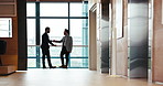 Businessmen, meeting and discussion with handshake for partnership, b2b or negotiation at office building. Business people, colleagues or employees shaking hands for agreement, teamwork or deal