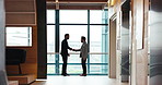 Businessmen, meeting and negotiation with handshake for b2b, partnership or introduction at office building. Business people, colleagues or employees shaking hands for agreement, teamwork or deal