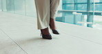 Business woman, walking or legs with high heels for commute, work trip or travel at office building. Feet, female person or strolling with formal shoes for corporate immigration on floor at workplace
