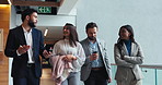 Teamwork, walking and discussion with business people at conference for networking, support and diversity. Seminar, convention center and tradeshow with group of employees in lobby for solidarity