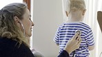 Father, baby and stethoscope of pediatrician for healthcare consultation, check lungs for breathing and heartbeat. Doctor, infant and assessment in clinic or hospital for medical analysis