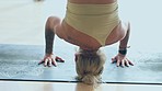 Yoga, fitness and handstand with a flexible woman in her home studio for a wellness or zen workout. Exercise, health and headstand with a young female yogi training her body for mental heath in a house