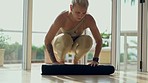 Woman, yoga mat and ready for home or studio fitness, holistic wellness and exercise gear. Pilates, workout and young person start training, meditation and zen or spiritual healing on ground