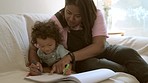 Playing, bonding and a mother drawing with a baby for education, learning and happiness. Family talking, care and a young mom teaching a child to draw on the living room sofa of a house together