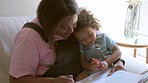 Learning, baby and mother writing, home and bonding with happiness, education and drawing. Family, mama and infant with female parent, newborn and child development with a book, creative and growth