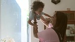 Home, mother and baby playing, airplane and happiness with joy, bonding and quality time. Family, mama or newborn with female parent, kid or child development with trust, activity or love in a lounge