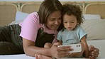 Phone, family or love with a mother and daughter taking a selfie on a bed in their home together. Baby, social media and child development with a woman teaching her infant about photograph technology