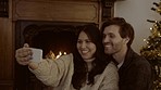 Young couple, video call and Christmas on chat, communication or festive wish on web in home living room. Happy man, woman and webinar with smile, hug and holiday with tree, culture or xmas tradition