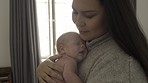 Mother with baby, love and family with bonding for relationship, hug and cuddle child at home. Woman rock newborn to sleep, new mom and affection with care in bedroom