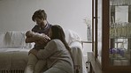 Happy mother and father with a baby on the sofa for love, care and comfort. Smile, home and a new family holding a newborn child for bonding as a parent in the living room together