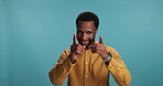 Pointing, finger guns and face of black man in studio for decision, opportunity and motivation. Choice, celebration and promotion with person on blue background for bonus, vote and achievement emoji