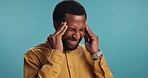 Frustrated, black man and stress with headache for strain, vertigo or dizziness on a blue studio background. Tired African, male person or model with migraine, pain or discomfort for bad pressure