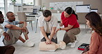 Cpr, learning and mannequin with man and instructor for First aid, workshop and training. Healthcare, safety course and emergency with people in class for paramedic demonstration, teaching and rescue