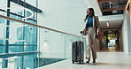Business woman, walking and travel with suitcase for immigration or work trip at office building. Female person, employee or immigrant with luggage for job opportunity or new career at workplace