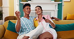 Happy couple, relax and watching tv with remote on sofa for movie, entertainment or shows at home. Man, woman or lovers with smile or online streaming for series, bonding or genre choice at house