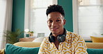 Man, face and relax with laughing in home for funny joke, resting and comfortable on sofa on weekend. Happy, person and portrait on couch in lounge with confidence, humor and comic break in house