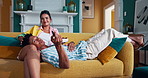 Happy couple, relax and watching tv with snacks on sofa for movie, entertainment or shows at home. Man, woman or lovers with smile or online streaming for series, bonding or holiday together at house