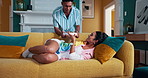 Surprise, food and sleeping with couple on sofa for wake up, valentines day gift and romance. Breakfast, love and happiness with man and woman in living room at home for present, support and relax