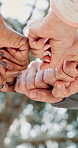 People, fist bump or nature with unity for motivation, solidarity or trust in support at outdoor park. Closeup, group touch or union with hands together for teamwork, mission or agreement in forest