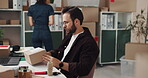 Small business, entrepreneur and man with box, order and laptop for printing of shipping label and ecommerce. Logistics, supply chain and people in startup with stock, online or planning for delivery