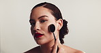 Woman, foundation and sponge for face in studio with application, test and beauty by white background. Girl, tools and process with makeup, skin and glow with blender for transformation in Colombia