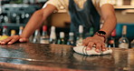 Hands, bar and hygiene for table, cleaning and bartender with cloth for bacteria, disinfection and person. Business, employee and wiping of counter for dirt, hospitality and prevention of germs