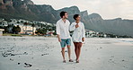 Couple, walking and love at beach outdoor for summer vacation, bonding together and ocean travel. People, journey and support with kiss for holiday getaway, relationship commitment and date adventure
